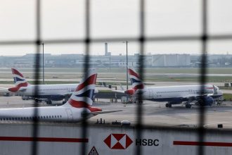 Airplanes remain parked on the tarmac at Heathrow International Airport following a fire at a nearby electrical substation that wiped out the power at the airport on Friday.