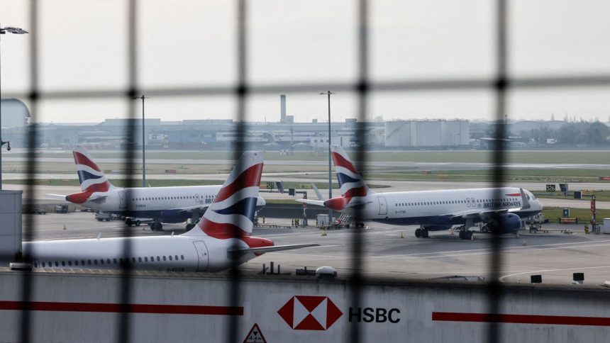 Airplanes remain parked on the tarmac at Heathrow International Airport following a fire at a nearby electrical substation that wiped out the power at the airport on Friday.