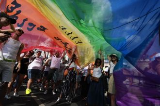 People taking part in a parade at Budapest Pride, held in Hungary's capital city, in July 2022.