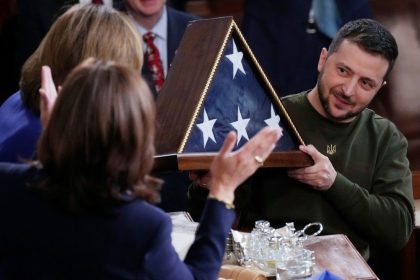 Ukrainian President Volodymyr Zelenskyy holds an American flag that was gifted to him by House Speaker Nancy Pelosi of Calif., after he addressed a joint meeting of Congress on Capitol Hill in Washington, Wednesday, Dec. 21, 2022. (AP Photo/J. Scott Applewhite)