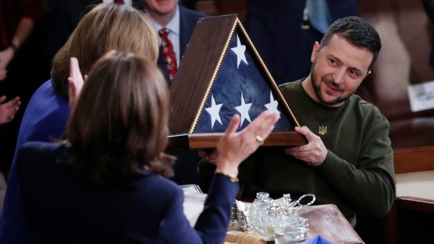 Ukrainian President Volodymyr Zelenskyy holds an American flag that was gifted to him by House Speaker Nancy Pelosi of Calif., after he addressed a joint meeting of Congress on Capitol Hill in Washington, Wednesday, Dec. 21, 2022. (AP Photo/J. Scott Applewhite)