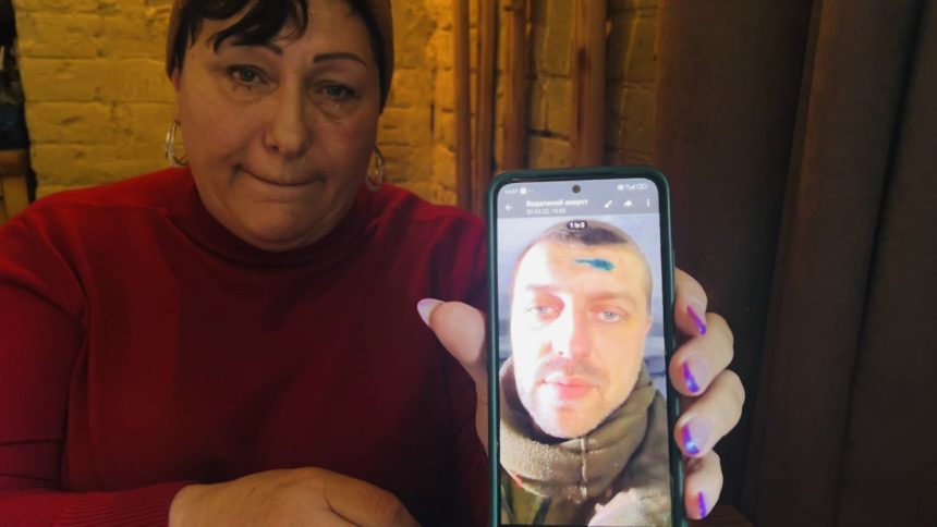 Valentyna Ocheretnaya shows the last photo she has of her son, Nazar Ocheretnyi, sent by him in March 2022 from Mariupol. She was informed two weeks later that he was "missing in action."