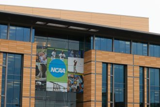 NCAA logo and signage are displayed outside the National Collegiate Athletic Association headquarters in Indianapolis.