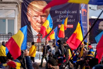 Supporters of Calin Georgescu march past a banner of Donald Trump reading "Republicans for Freedom" in Bucharest, Romania, February 22, 2025.