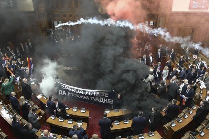 In this screen grab, taken from video provided by RTS Serbia, smoke bombs and flares are seen inside parliament, in Belgrade, Serbia on Tuesday.