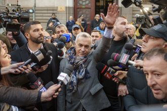 Calin Georgescu waves to supporters after leaving a court in Bucharest, Romania, March 5, 2025.