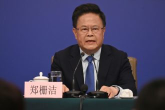 Zheng Shanjie, chairman of China's National Development and Reform Commission, speaks to journalists at a news conference in Beijing on March 6, 2025.