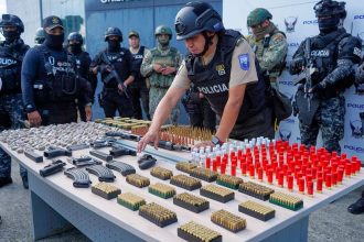 Ecuadorian police display weapons and ammunition seized after a deadly armed attack in Guayaquil.