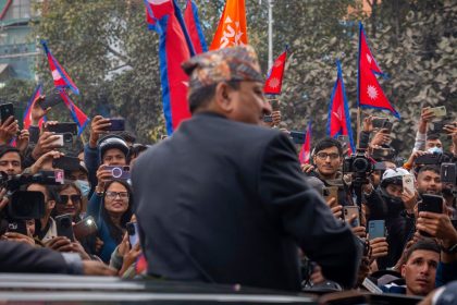 Former King Gyanendra Shah of Nepal waves upon his arrival at Tribhuvan International Airport in Kathmandu, Nepal, on Sunday, March 9, 2025.