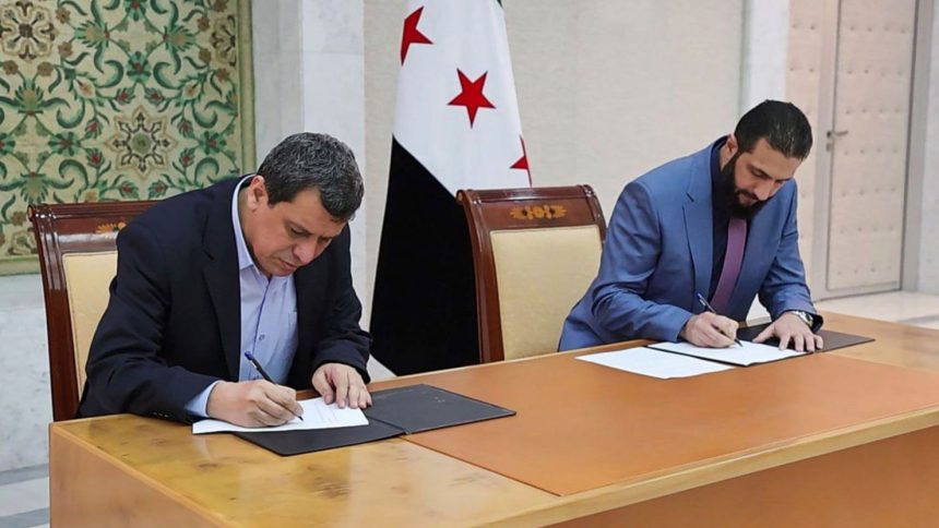 Syria's interim President Ahmad al-Sharaa, right, and Mazloum Abdi, the commander of Kurdish-led Syrian Democratic Forces, sign a deal in Damascus, Syria, on Monday.