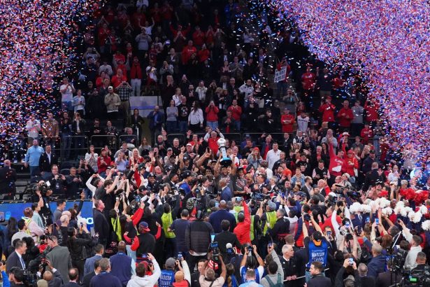 St. John's Zuby Ejiofor holds celebrates with teammates while holding the tournament trophy after an NCAA college basketball game against Creighton in the championship of the Big East Conference tournament.