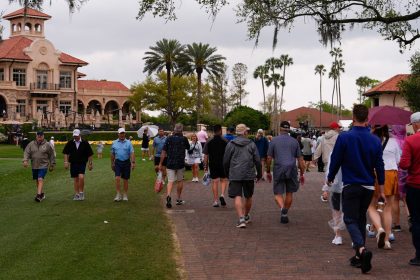 Fans walk near the clubhouse during the final round of The Players Championship golf tournament Sunday in Ponte Vedra Beach, Florida.