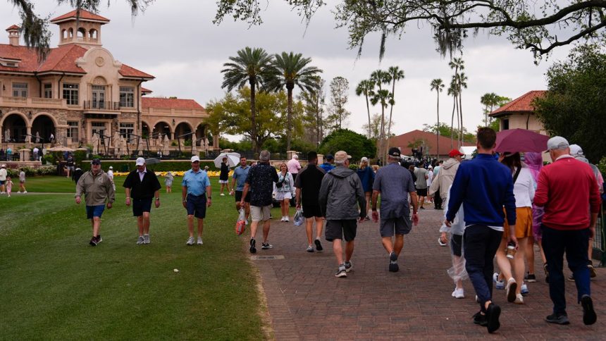 Fans walk near the clubhouse during the final round of The Players Championship golf tournament Sunday in Ponte Vedra Beach, Florida.