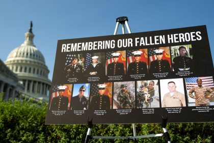 A sign displaying photos and names of the 13 service members killed in a terrorist attack at Abbey Gate outside Kabul's Hamid Karzai International Airport is seen during a news conference at the U.S. Capitol on September 9, 2024 in Washington, DC.