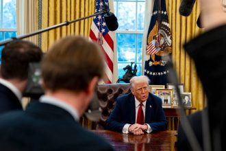 President Donald Trump speaks to members of the press after signing two executive orders in the Oval Office of the White House on January 30 in Washington, DC.