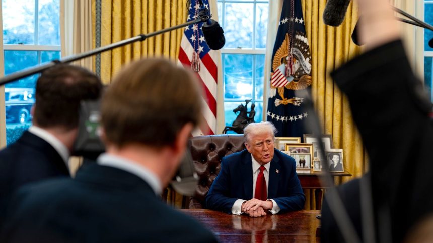 President Donald Trump speaks to members of the press after signing two executive orders in the Oval Office of the White House on January 30 in Washington, DC.