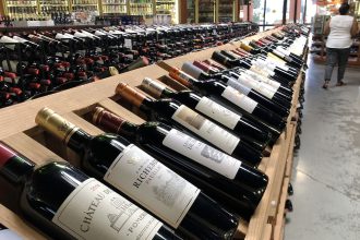 Bottles of French wine are displayed for sale in a liquor store.