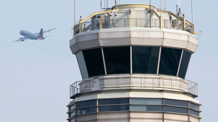 An American Airlines airplane takes off past the air traffic control tower at Ronald Reagan Washington National Airport in Arlington, Virginia, on January 11, 2023.