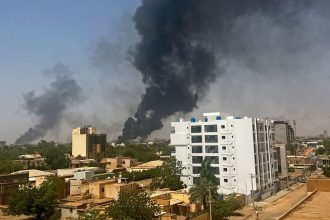 Smoke billows above residential buildings in Khartoum on April 16, 2023.