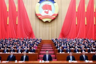 Chinese leader Xi Jinping, center, attends a meeting at Beijing's Great Hall of the People during China's annual two sessions political gathering last March.