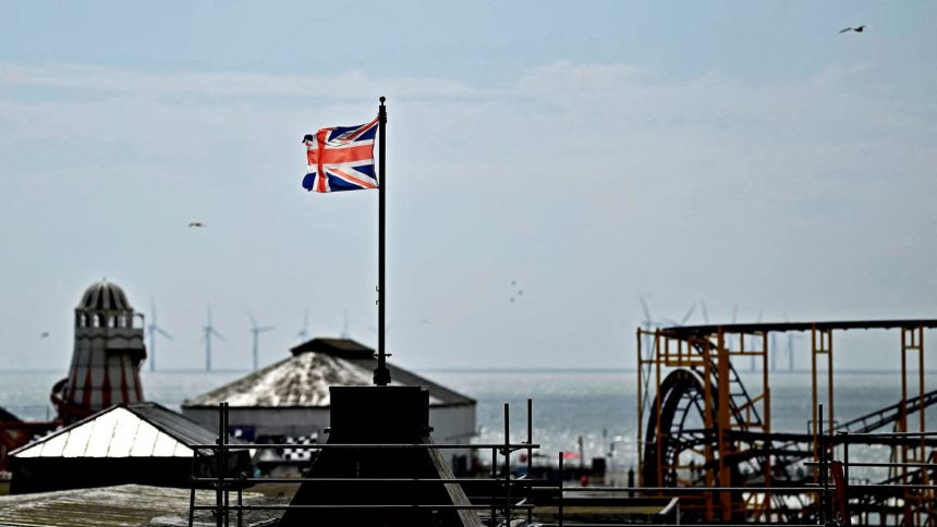 A Union Jack flag flies from a pole above Clacton Pier in Clacton-on-Sea, eastern England, on June 4, 2024.