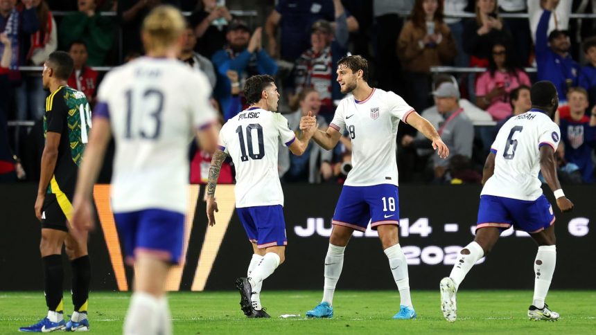 Christian Pulisic (No. 10) and Tanner Tessmann (No. 18) of the United States celebrate a goal during a November Concacaf Nations League quarterfinal match against Jamaica.