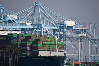 Cargo shipping containers sit on the Evergreen Ever Fame container ship docked at a container terminal at the Port of Los Angeles in Los Angeles, California on February 3, 2025.