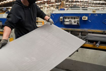 A worker feeds sheet aluminum into a machine at an auto parts manufacturer in San Luis Potosi, San Luis Potosi state, Mexico, on Monday, Feb. 17, 2025.