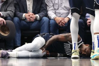 Kyrie Irving lies on the court after suffering an injury against the Sacramento Kings on Monday.