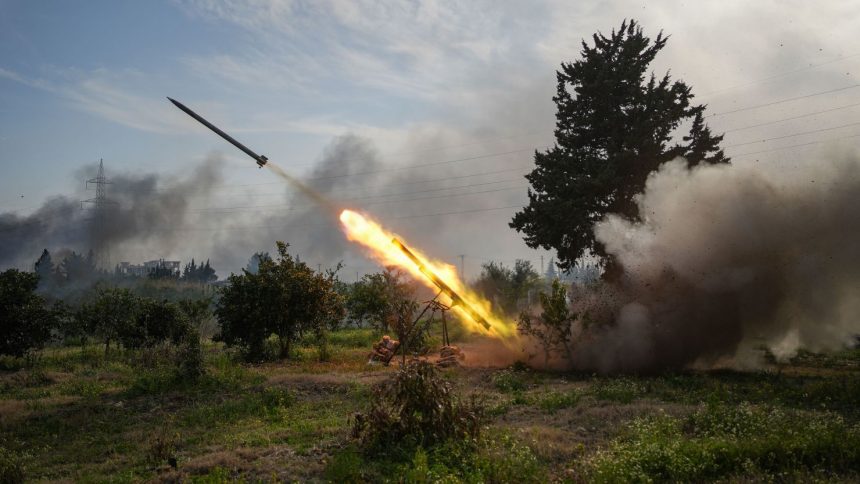 Syrian Army forces fire a missile while battling fighters linked to Syria's ousted president Bashar al-Assad in Latakia, Syria, on Friday.