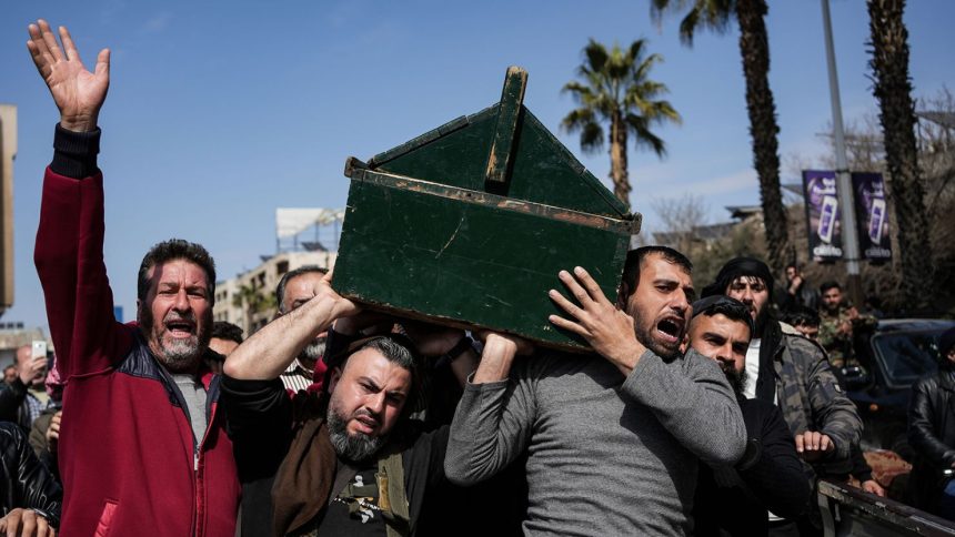 Syrian fighters and civilians carry the coffin of a member of the Syrian security forces during his funeral in Hama province, on March 9, 2025, after he and 11 other colleagues were killed in an ambush by groups loyal to the ousted President Bashar al-Assad in Latakia.