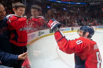 Alex Ovechkin of the Washington Capitals celebrates with his son Sergei after his team beat the Seattle Kraken at Capital One Arena in Washington, DC, on Sunday.