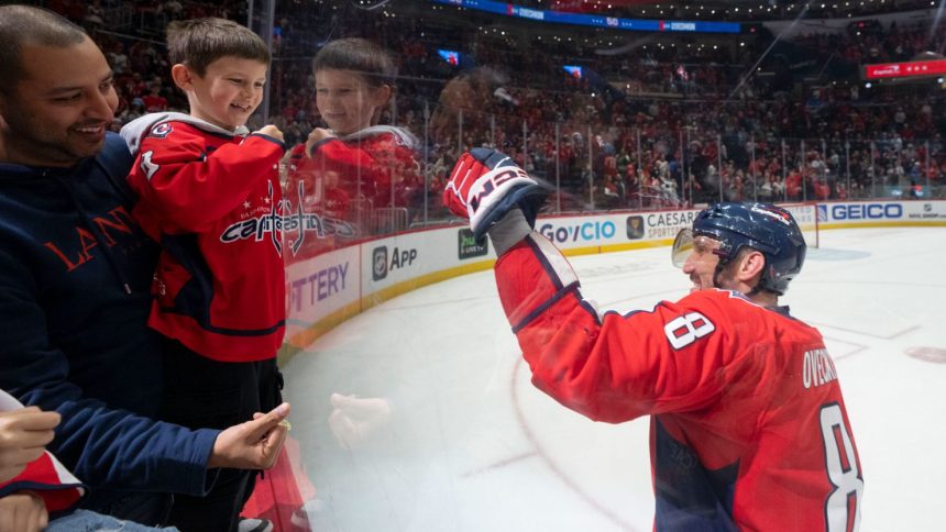 Alex Ovechkin of the Washington Capitals celebrates with his son Sergei after his team beat the Seattle Kraken at Capital One Arena in Washington, DC, on Sunday.