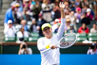 Iga Świątek celebrates defeating Karolína Muchová in the fourth round of the BNP Paribas Open at Indian Wells on March 11.