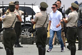 Ecuador's President Daniel Noboa arrives at a ceremony to hand over 120 patrol cars to the National Police in Guayaquil, Ecuador on March 14, 2025.