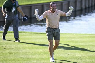 A soaked Tosti celebrates his hole-in-one at TPC Sawgrass.