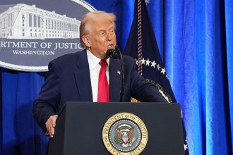 President Donald Trump speaks at the Justice Department on Friday.