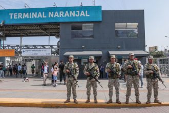 Military forces stand guard outside the Naranjal Metropolitano transport station in Lima on March 18, 2025, a day after Peru declared a month-long state of emergency in the capital after a wave of killings linked to extortion.