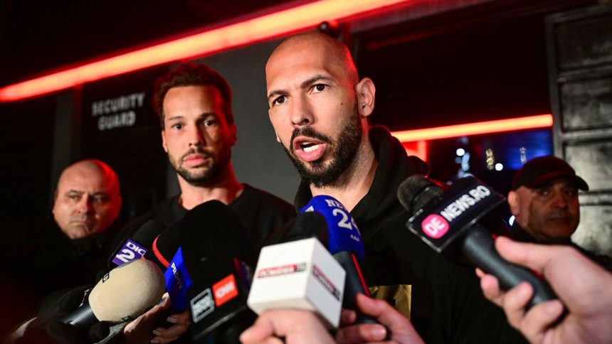 Andrew Tate, right and his brother Tristan, center, speak to the media as they arrive in Bucharest, Romania back from US, on Saturday.