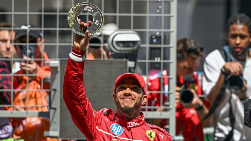 Lewis Hamilton celebrates winning the sprint race at the Chinese Grand Prix, his first victory at Ferrari.