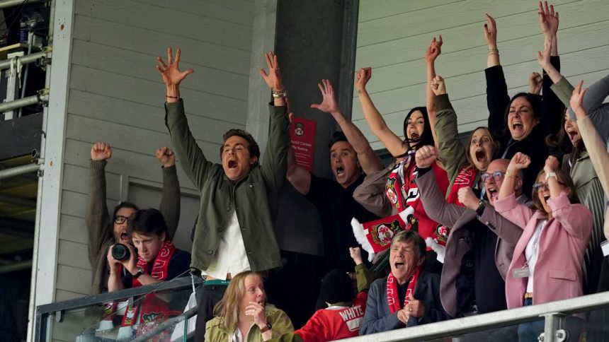 Wrexham co-owners Ryan Reynolds (left) and Rob McElhenney celebrate after Wrexham scored their second goal Saturday.
