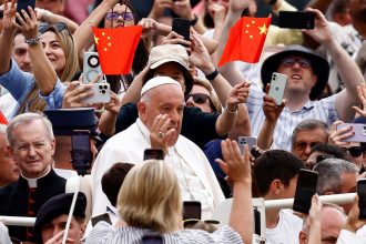 Pope Francis arrives for the weekly general audience as people wave Chinese flags at Saint Peter's Square at the Vatican, June 19, 2024.