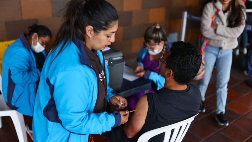 A man is vaccinated during a campaign of vaccination against yellow fever at the transport terminal, after the Colombian government declared a health emergency due to the increase in infections, in Bogota, Colombia April 17, 2025.