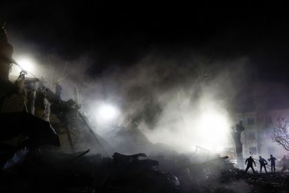 Rescuers work at the site of an apartment building in Kyiv, Ukraine that was hit by a Russian ballistic missile strike on Thursday.