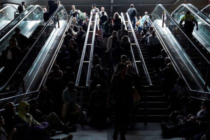 People wait on the stairs at Atocha train station in Madrid, during a massive power outage that left Spain and Portugal in the dark for hours.