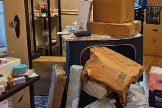 Packages seen in the home of Phillip Dampier, a 57-year-old who orders from Temu and other Chinese e-commerce sites.