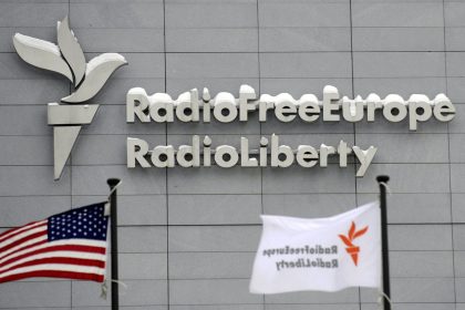 In this Friday, Jan. 15, 2010 file photo, the headquarters of Radio Free Europe/Radio Liberty (RFE/RL) is seen with the United States flag in the foreground, in Prague.