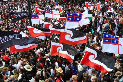 Thousands of people gather outside New Zealand's parliament in November 2024 to protest a proposed law that would redefine the country's founding agreement