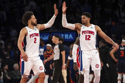 Detroit Pistons guard Cade Cunningham, left, and forward Tobias Harris high-five at the end of their Game 2 win against the New York Knicks on Monday.