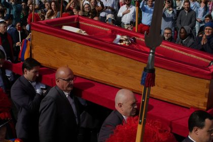 The body of Pope Francis is carried into St. Peter's Basilica at the Vatican, Wednesday, April 23, 2025, where he will lie in state for three days. (AP Photo/Emilio Morenatti)